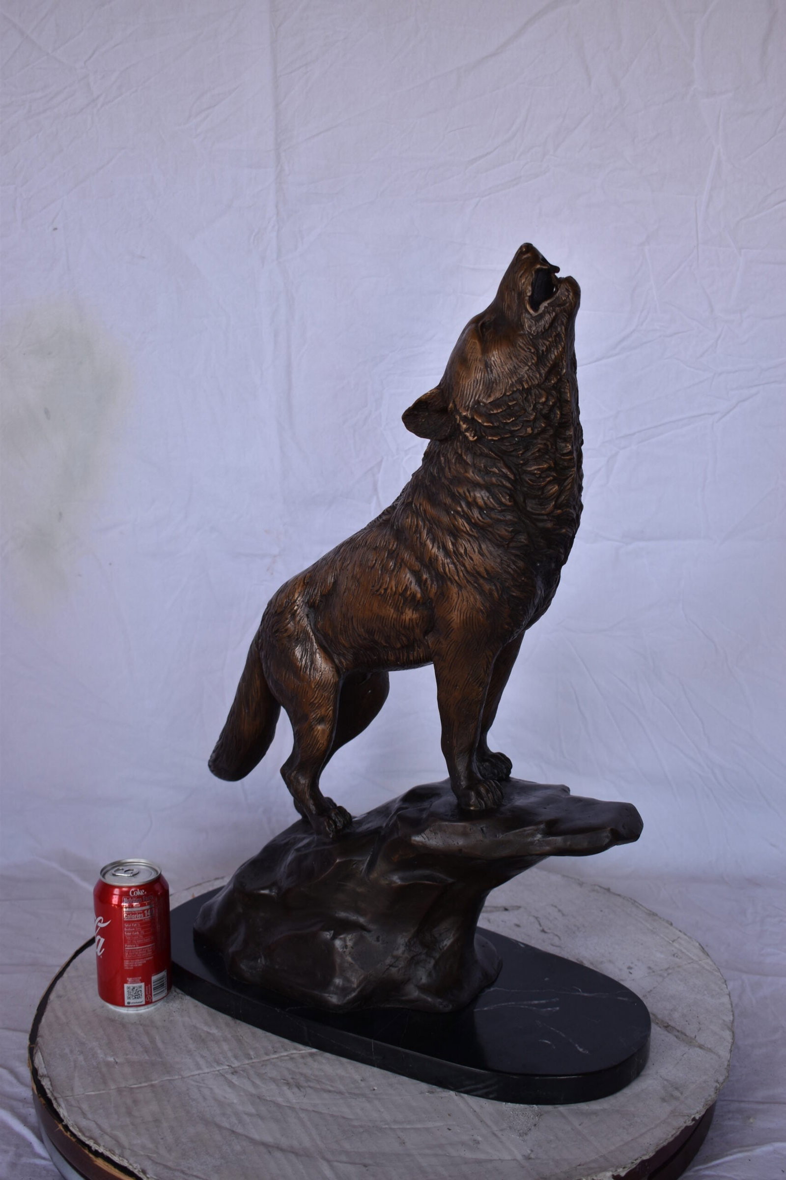 Howling Wolf at Edge of a Cliff Bronze Statue - Size: 9"L x 20"W x 26"H. - 3