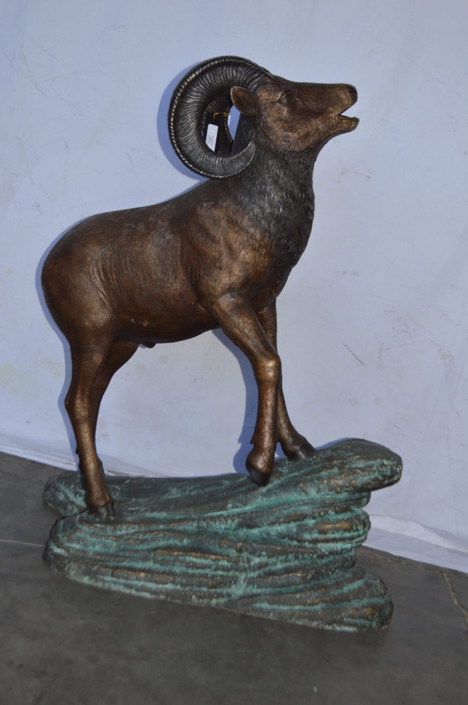 Life Size Ram standing on a rock Bronze Statue - Size: 38"L x 19"W x 45"H. - 5