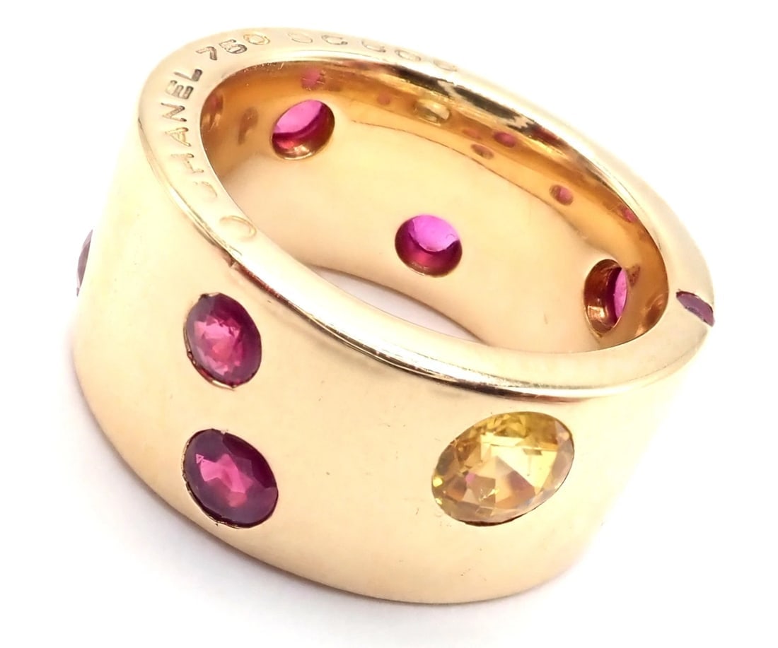 Authentic! Chanel 18k Yellow Gold Ruby Yellow Sapphire Wide Band Ring Size 5: Authentic! Chanel 18k Yellow Gold Ruby Yellow Sapphire Wide Band Ring Size 5 About This Piece: Metal: 18k Yellow Gold Measurements: Size:5 Width: 10mm Weight: 16.5 grams Stones: 1 Yellow Sapphire tota