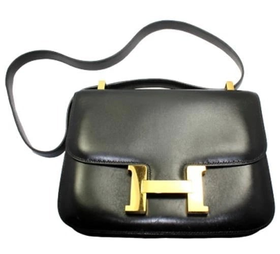 AUTHENTIC HERMES 23CM BLACK BOX LEATHER GHW CONSTANCE HANDBAG: AUTHENTIC HERMES 23CM BLACK BOX LEATHER GHW CONSTANCE HANDBAG About This Piece: *Please note, color may not be fully representative of handbag based on monitor and lighting. This handbag is dark (almo