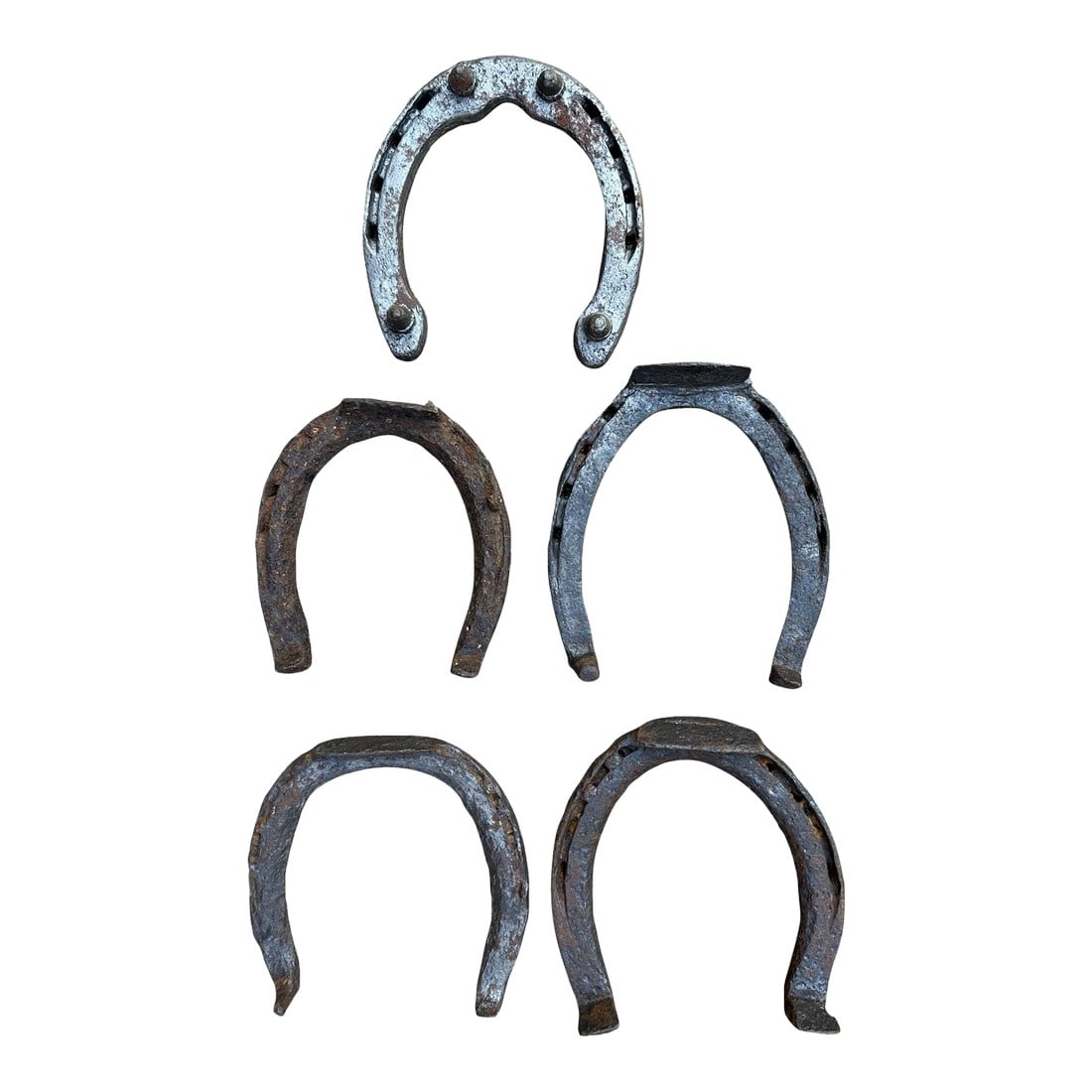Early 20th Century Rustic Horseshoes Wall Decor- Set of 5: Antique and vintage set of horseshoes to enhance a ranch-cabin-farmhouse to industrial home. Adorn your front door, or entry as a sign of welcome and good luck. Add to a decor grouping for your