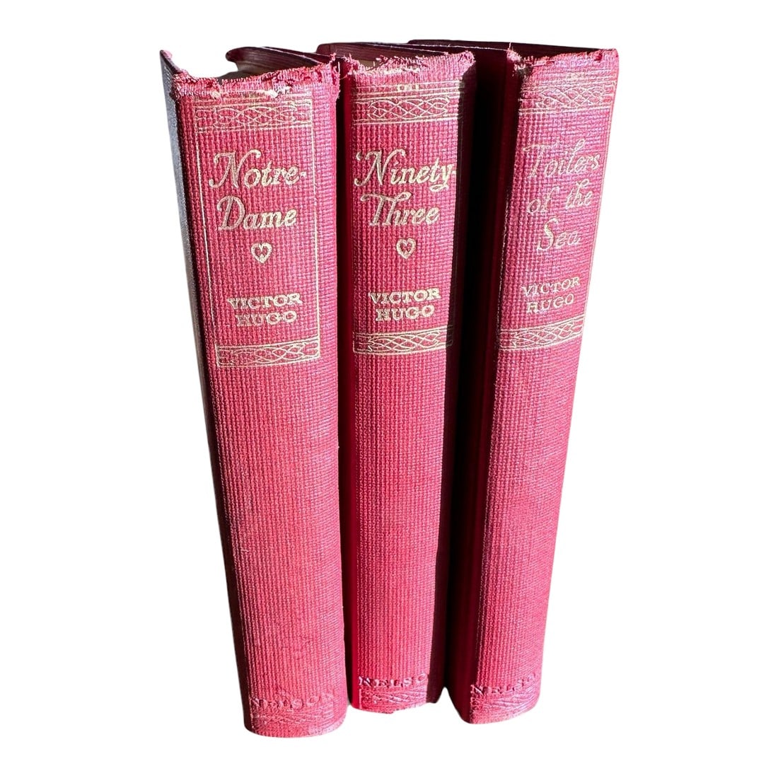 Antique Red Hardcover Victor Hugo Books- Set of 3: Antique set of 3 decorative embossed red cloth cover books by Victor Hugo No publication date-estimate circa 1915 This set is in very poor condition Titles: Notre Dame, The Toilers of The Sea, and