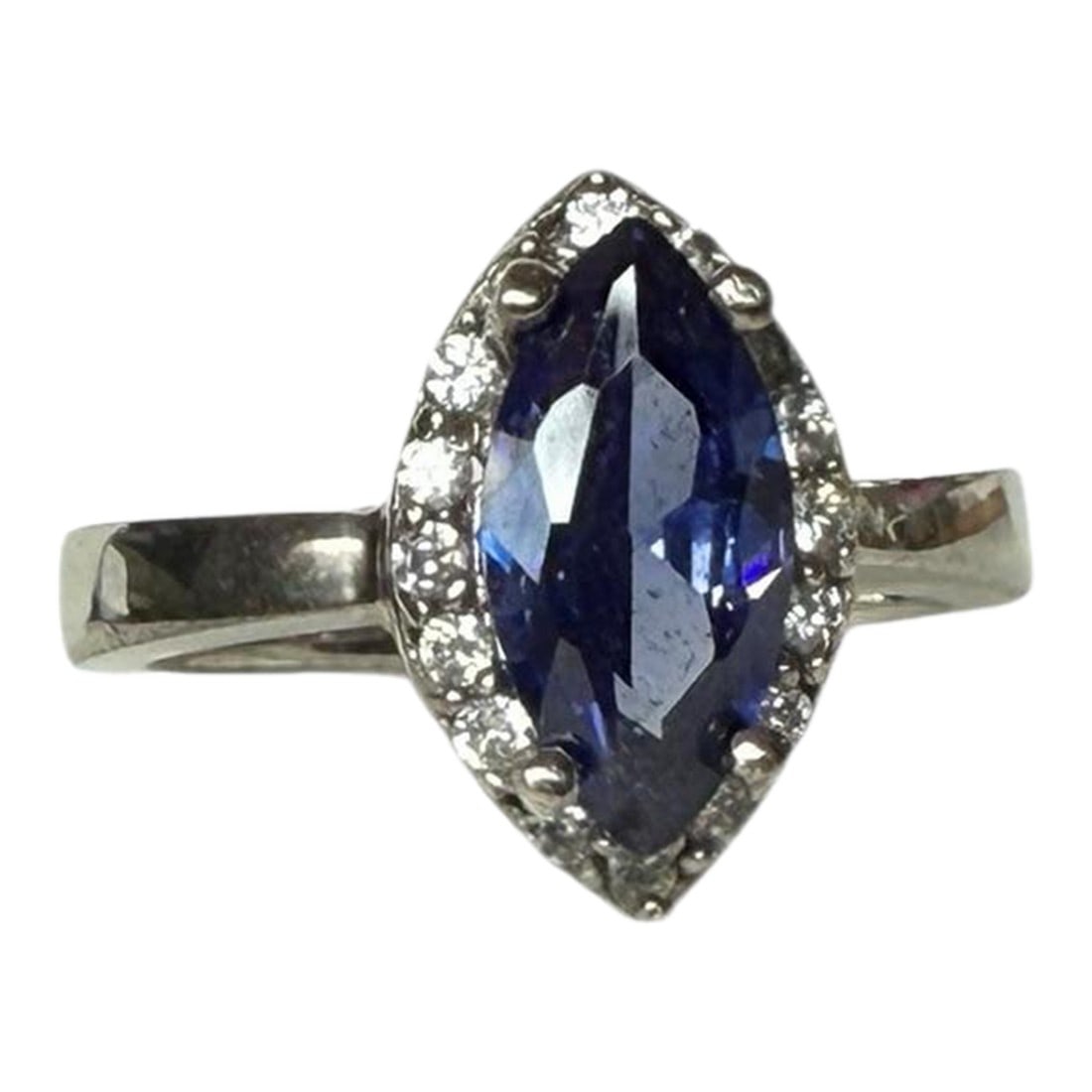 Tanzanite Marquis Cut Sterling Silver Cocktail Ring Cz Accents, Size 6.75: Marked 925, this ring features a large marquise-cut tanzanite gemstone at it's center. The center stone is surrounded by a halo of smaller cubic zirconia round accents in a prong setting. 6.75 ring