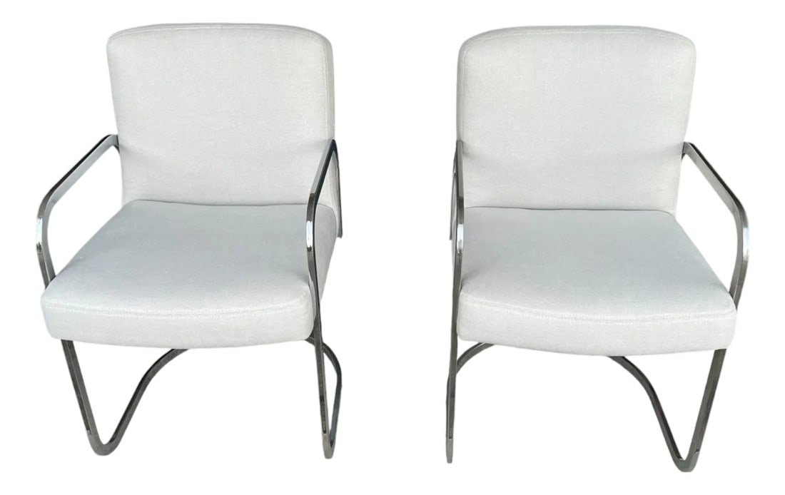 Set of 2 1960s Mid-Century Modern Chrome Cantilever Armchairs – Restored & Reupholstered: This exceptional pair of mid-century modern armchairs dates back to the 1960s, showcasing the sleek, sculptural aesthetics that defined the era. Crafted with a bent-tube chrome cantilever frame, the c