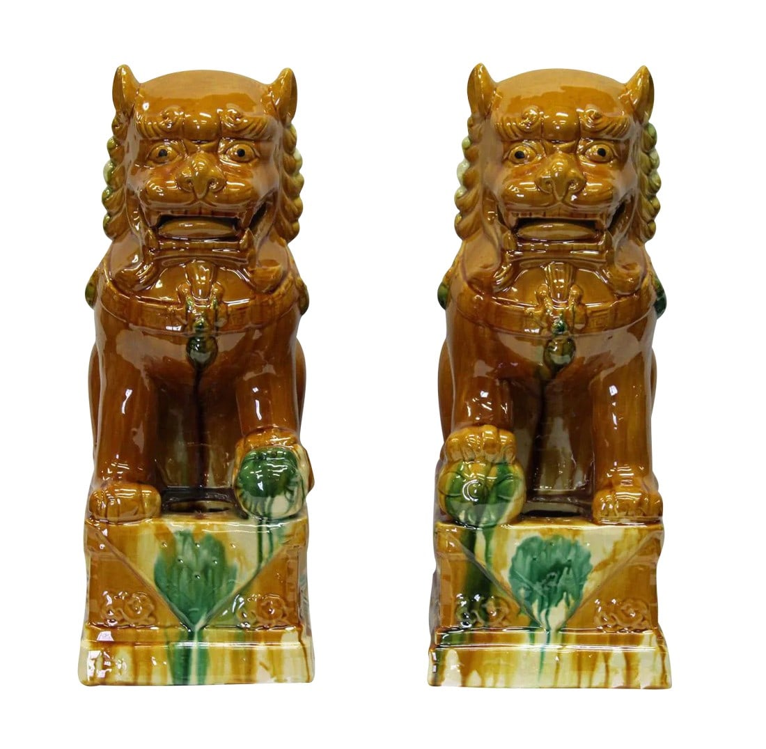 Chinese Brown Glazed Ceramic Foo Dogs - A Pair: This is a pair of hand made ceramic Foo Dog figures in a brown colored glaze finish. They are a traditional Chinese Feng Shui items as well as home decor. The finish is rough. There are lines, but