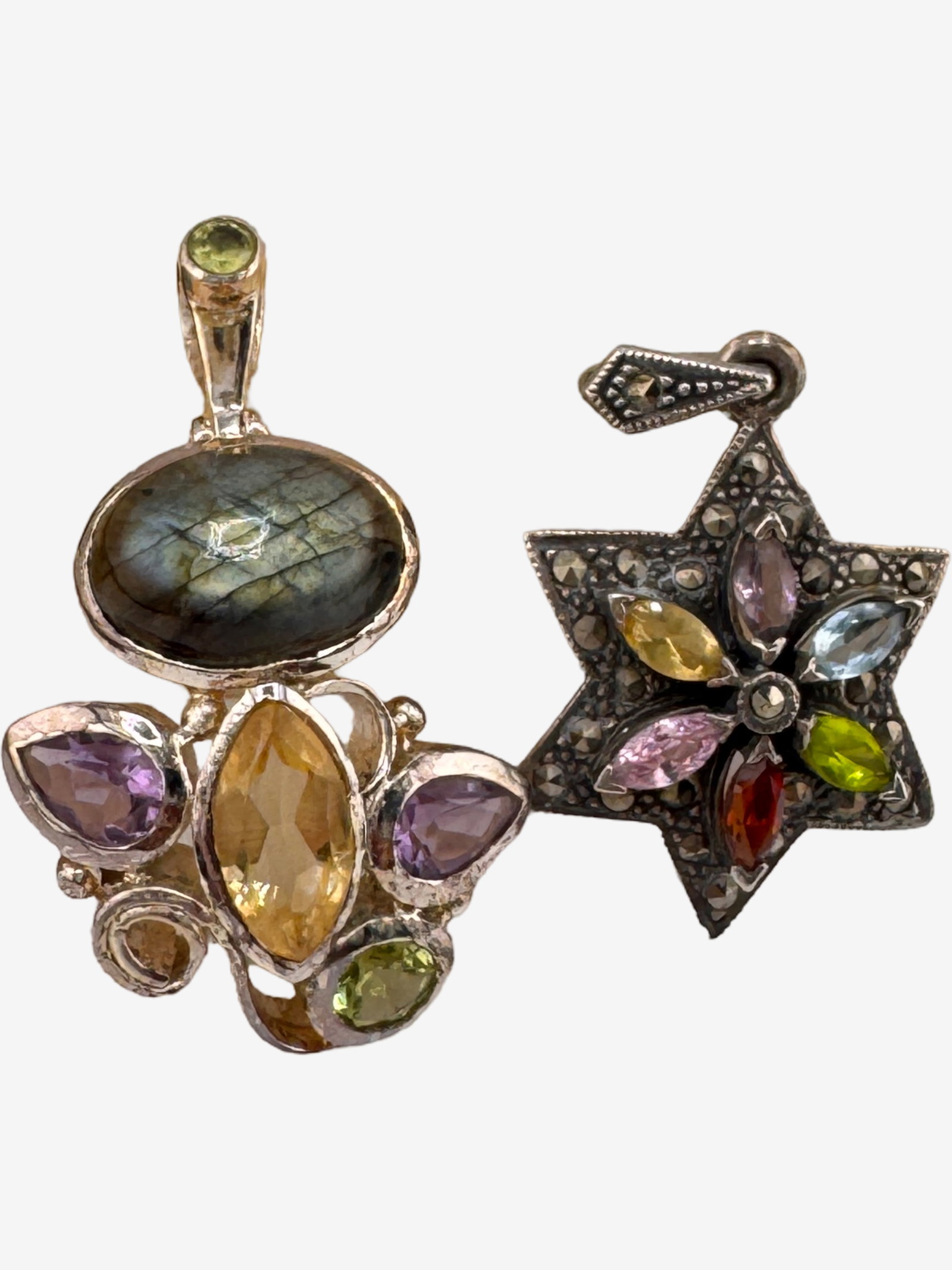 Two Sterling Silver and Multi-Gemstone Pendants: This lot features two distinctive sterling silver pendants, each adorned with an array of colorful gemstones. The first pendant is a larger (1 1/2"), more ornate piece, centered with a captivating