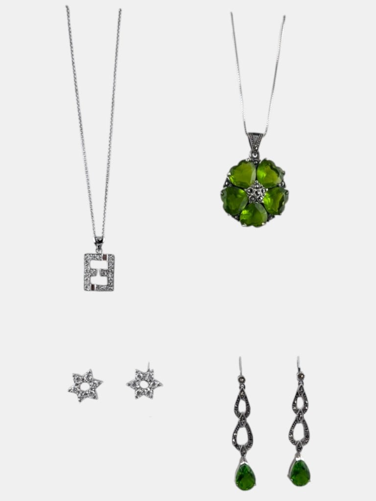 Collection of Sterling Silver and Peridot Jewelry: This exquisite collection features four distinct pieces of jewelry, crafted from a mix of sterling silver and adorned with vibrant peridot gemstones. The lot includes a delicate necklace with a pendan