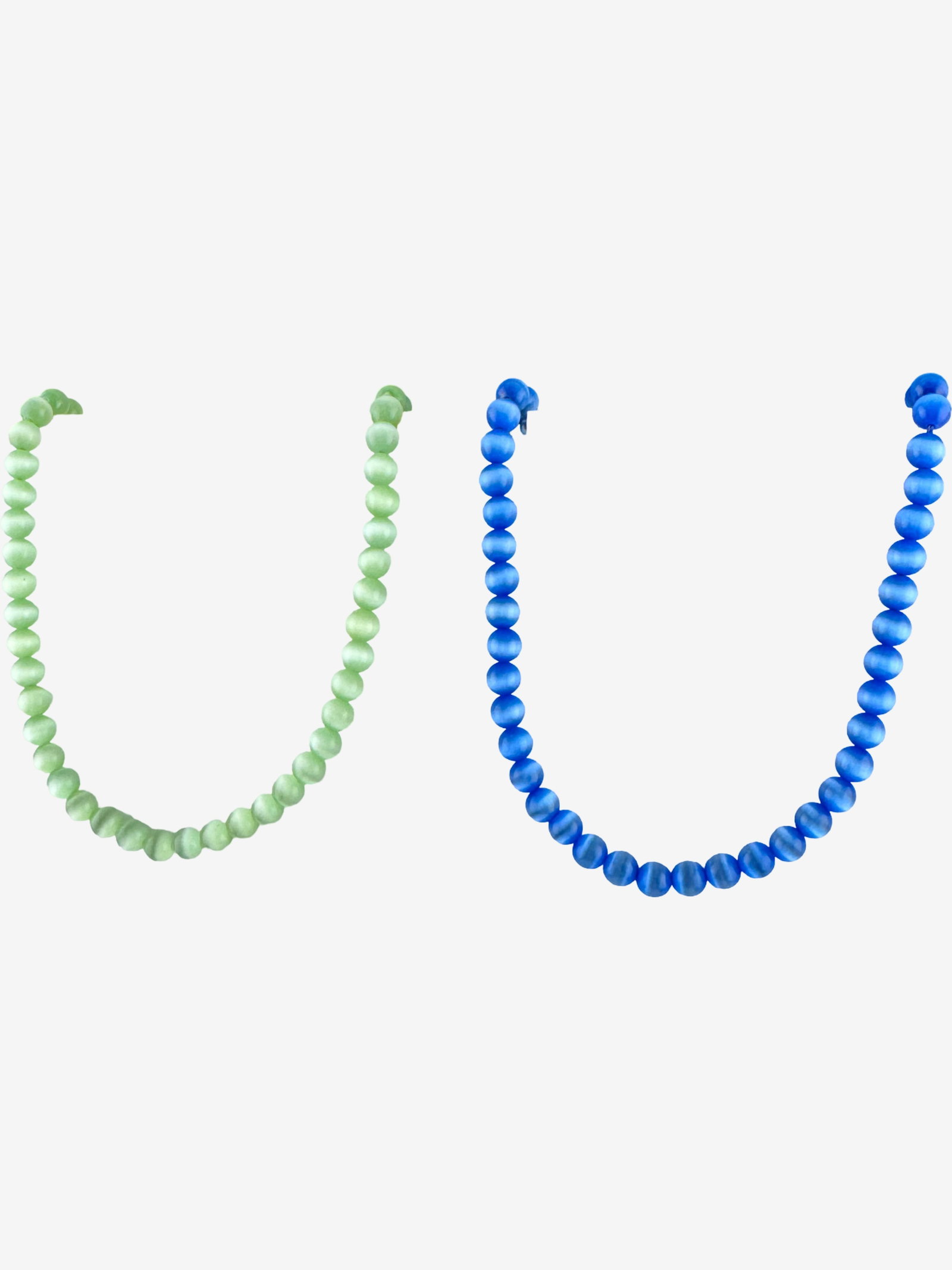 Pair of Beaded Necklaces: This lot features a pair of beaded necklaces, one in a vibrant green hue and the other in a serene blue. Each necklace is composed of numerous polished, spherical "cat's eye" beads, exhibiting a