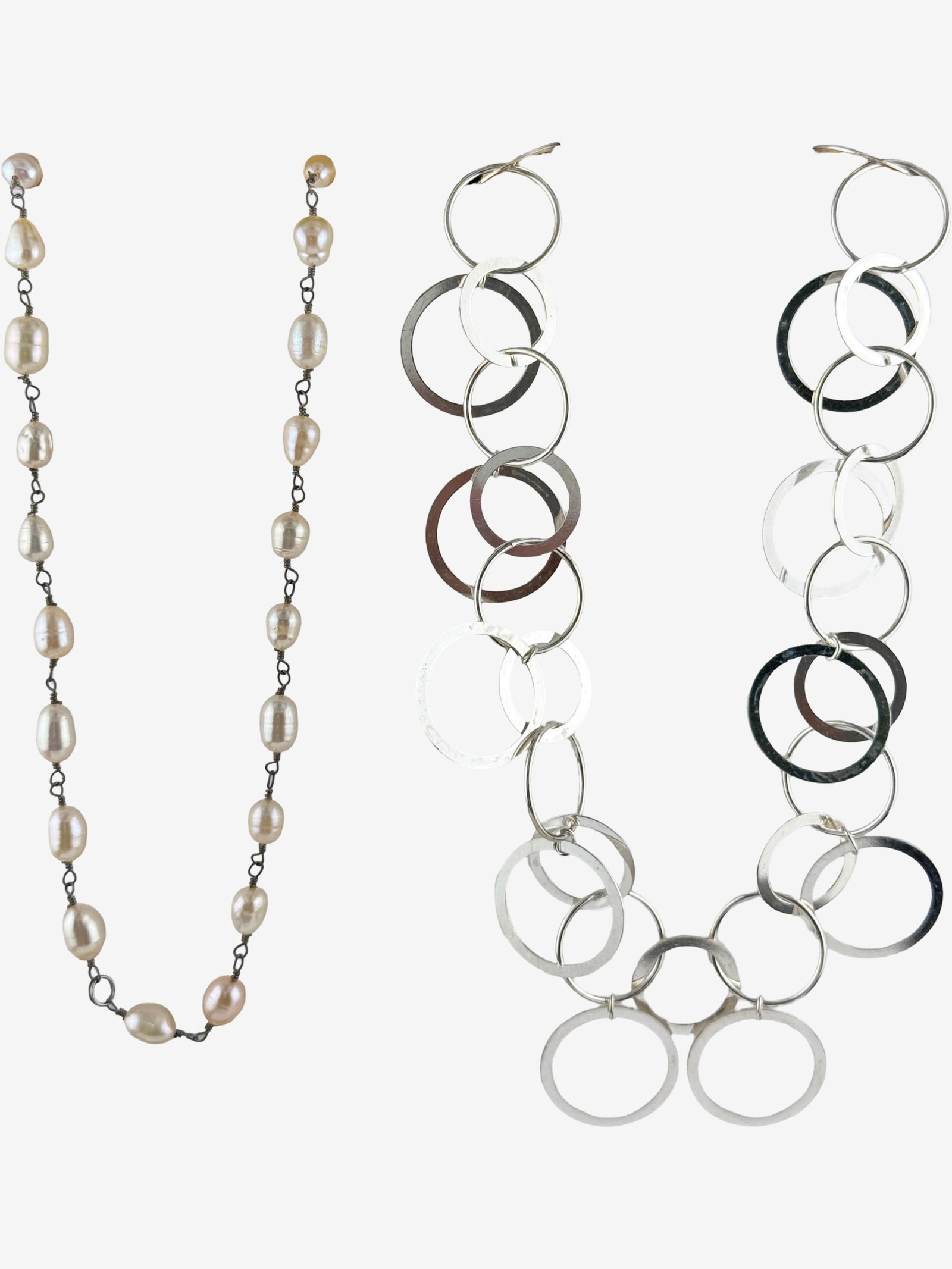Two Sterling Silver and Freshwater Pearl Necklaces: This lot includes two distinct necklaces. One is a lengthy necklace composed of multiple freshwater pearls, in a sterling silver lobster clasp. The pearls exhibit natural variations in shape and