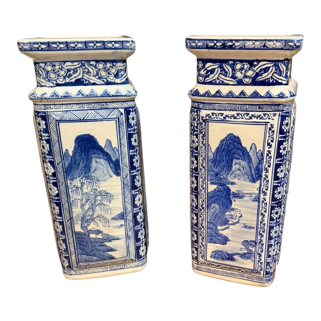 Vintage Chinese Qianlong Style Blue and White Porcelain Vases- a Pair: A pair of tall Chinese Blue and White Porcelain Vases with markings on the bottom. Hand painted scenery on 4 panels. Each scene on each panel on each vase varies. A floral inside border on one vase