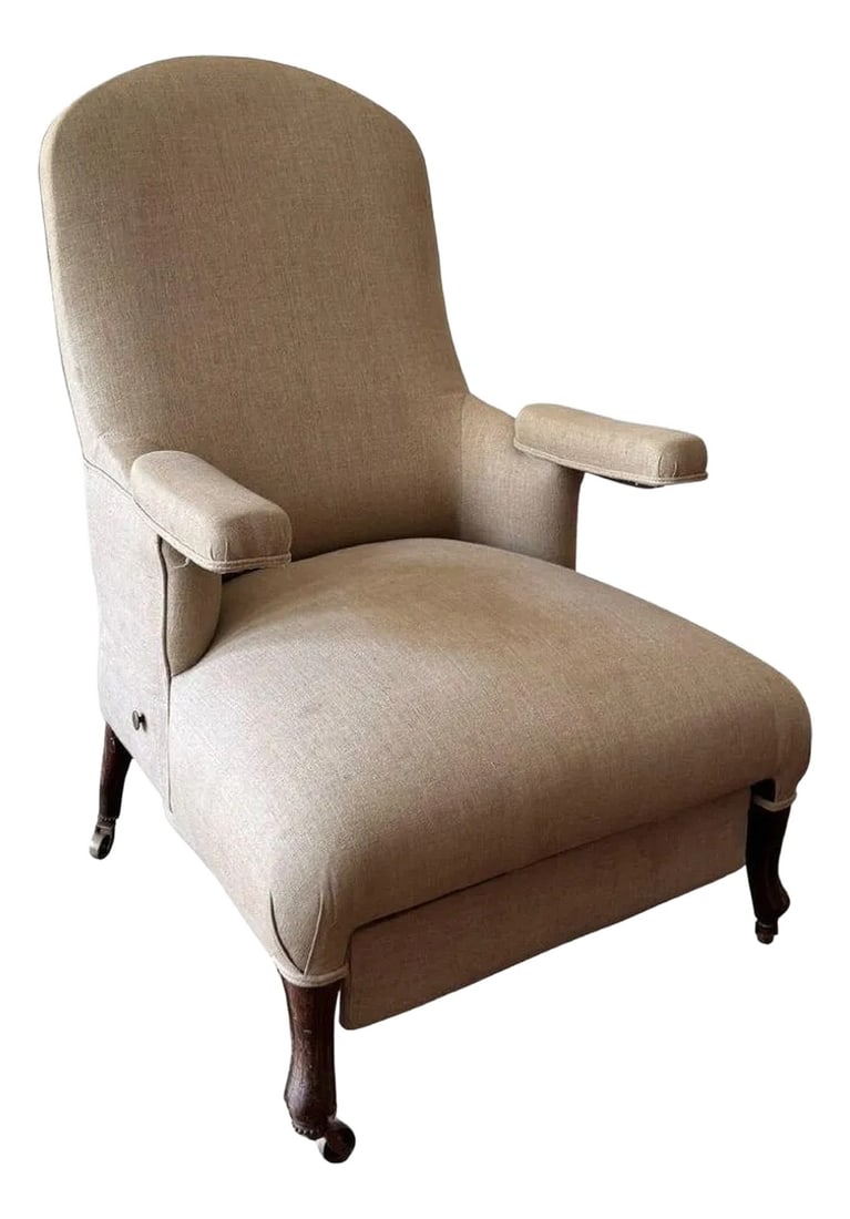 Napoleon III Mechanical Reclining Armchair Circa 1860: An elegant and extremely comfortable library chair of the Napoleon III period. The chair features a pull out ottoman that flips into place, arms that rotate outwards, and a mechanical reclining back.