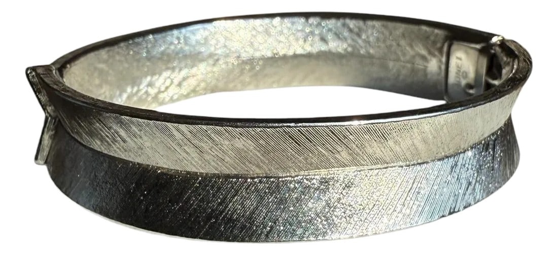 Mid 20th Century Monet Silvertone Textured Spring Clasp Cuff Bracelet: Modernist style Marked Monet Silver tone .25" wide spring clasp cuff. Angled inward with texture in chevron pattern. Excellent vintage condition Measures 2.5" long x 2.25" wide x .25" deep 
