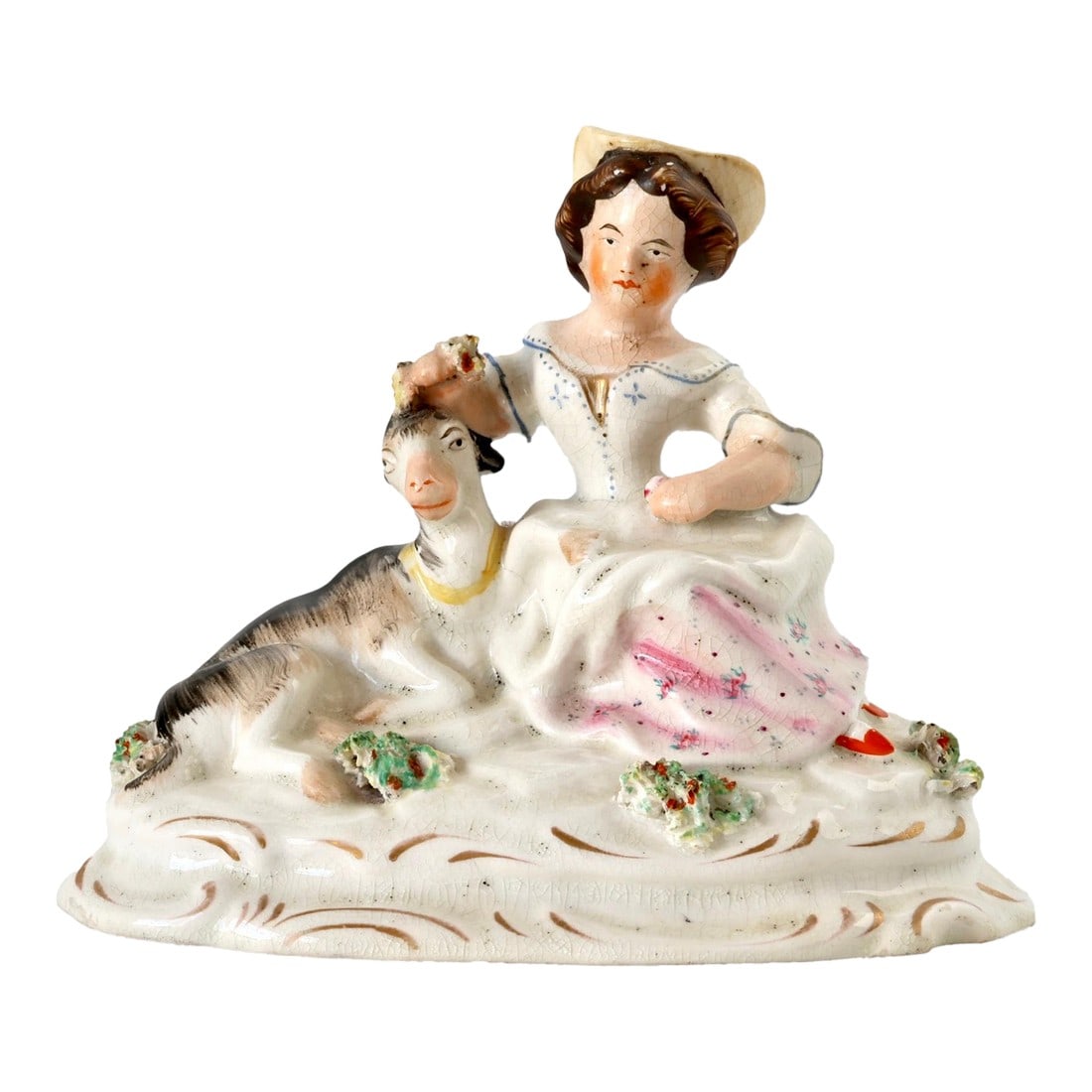Antique Staffordshire Girl W/Goat, Circa 1850: Charming mid-19th century Staffordshire figure depicting a seated woman beside a goat, with hand-painted florals and gilt detailing. Made in England circa 1850s, this rural-themed figurine showcases c