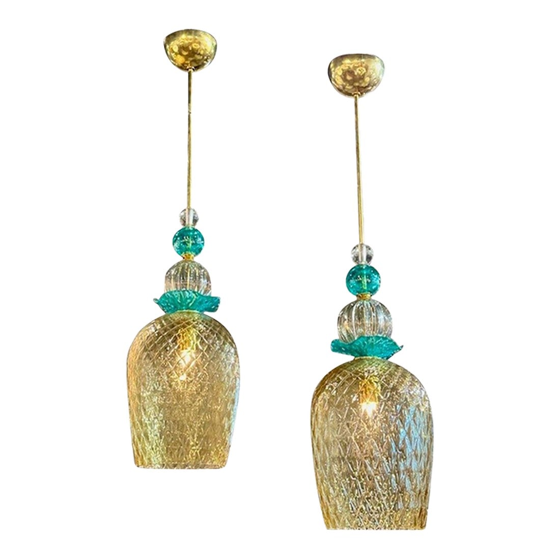 Pair of Modern Champagne Colored and Teal Murano Glass Pendants: Pair of modern Murano texured champagne and turquoise glass and pendant lights. Sure to make a statement! Condition: Alterations: Original Condition Unaltered Imperfections: Some Imperfections Conditi