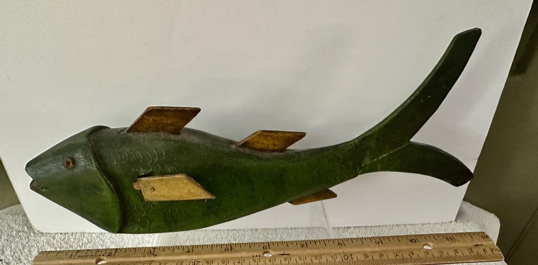 Large Carved Fish or Ice Fishing Lure: This large carved fish (perhaps an ice fishing decoy) retains its original green painted surface, glass eyes and metal fins. Its body, with a flat bottom, is slightly curved and it makes a wonderful s