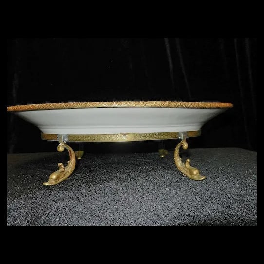 Antique Victorian Hand Painted Porcelain Plate with Ormolu Trim Serves Style: There are just no words to really describe this Antique Victorian Hand Painted Porcelain Plate with Ormolu Trim and Dolphin Footed Base. The plate is adorned with a charming couple mounted in gilt-bro