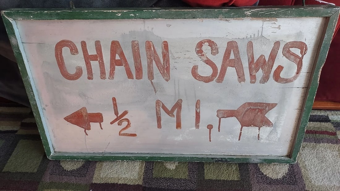 Chainsaw Repair Sign 1960 Painted 32 x 17 ": Great looking piece in very good condition. Rare piece and came from Vermont area. Reused sign. can make out sign underneath. Very common for things in New England to be reused. Measures approximately