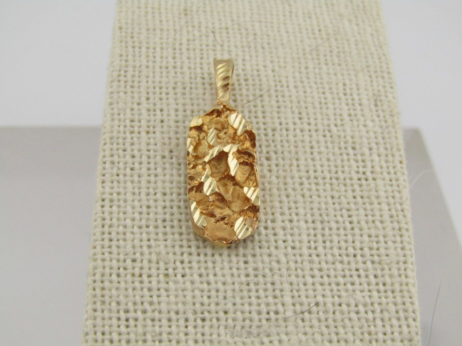 14kt Gold Nugget Pendant, 1", 2.18 grams, 1990's, Unisex: Title:14kt Gold Nugget Pendant, 1", 2.18 grams, 1990's, UnisexDescription:14kt Gold Nugget Pendant, 1", 2.18 grams, 1990's. This is a 14kt yellow gold nuggetlike pendant with diamond cut accents on