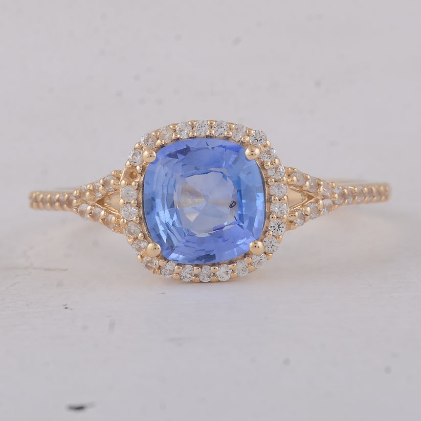 1.58 Ct Cushion Sapphire 9K Gold Ring: 1.58 Total Carat Sapphire 9K Gold Ring Specifications: Total Weight 1.77 g Center Gemstone Sapphire Gemstone Carat Weight 1.36 Carats Gemstone Measurements 6.90X6.50X3.30 mm Additional Gemstones
