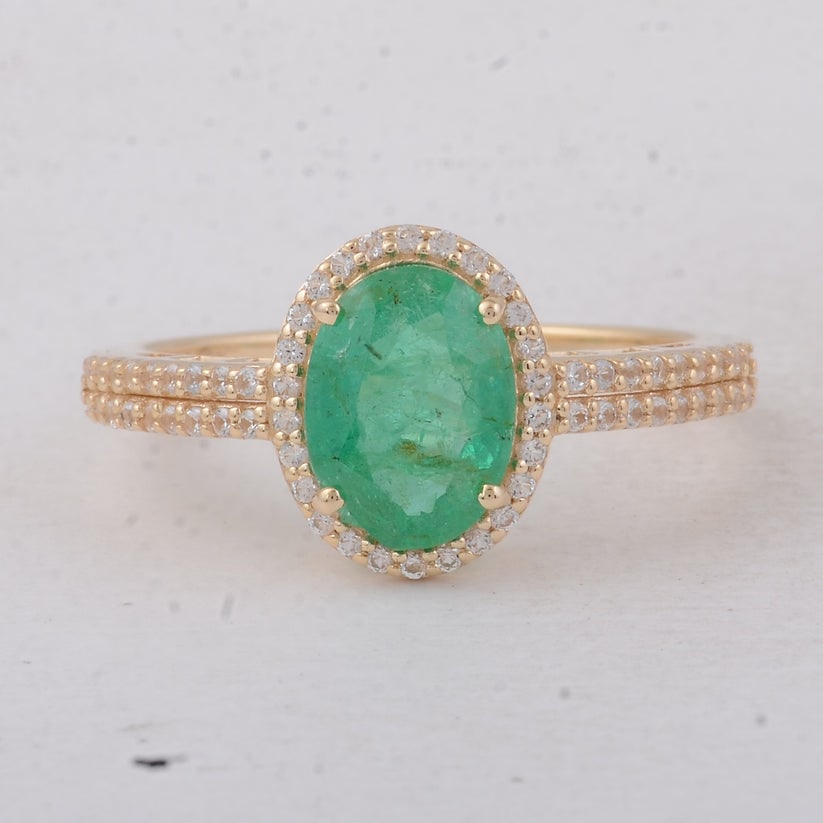 1.54 Ct Oval Emerald 9K Gold Ring: 1.54 Total Carat Emerald 9K Gold Ring Specifications: Total Weight 2.25 g Center Gemstone Emerald Gemstone Carat Weight 1.27 Carats Gemstone Measurements 8.70X6.50X3.80 mm Additional Gemstones White S