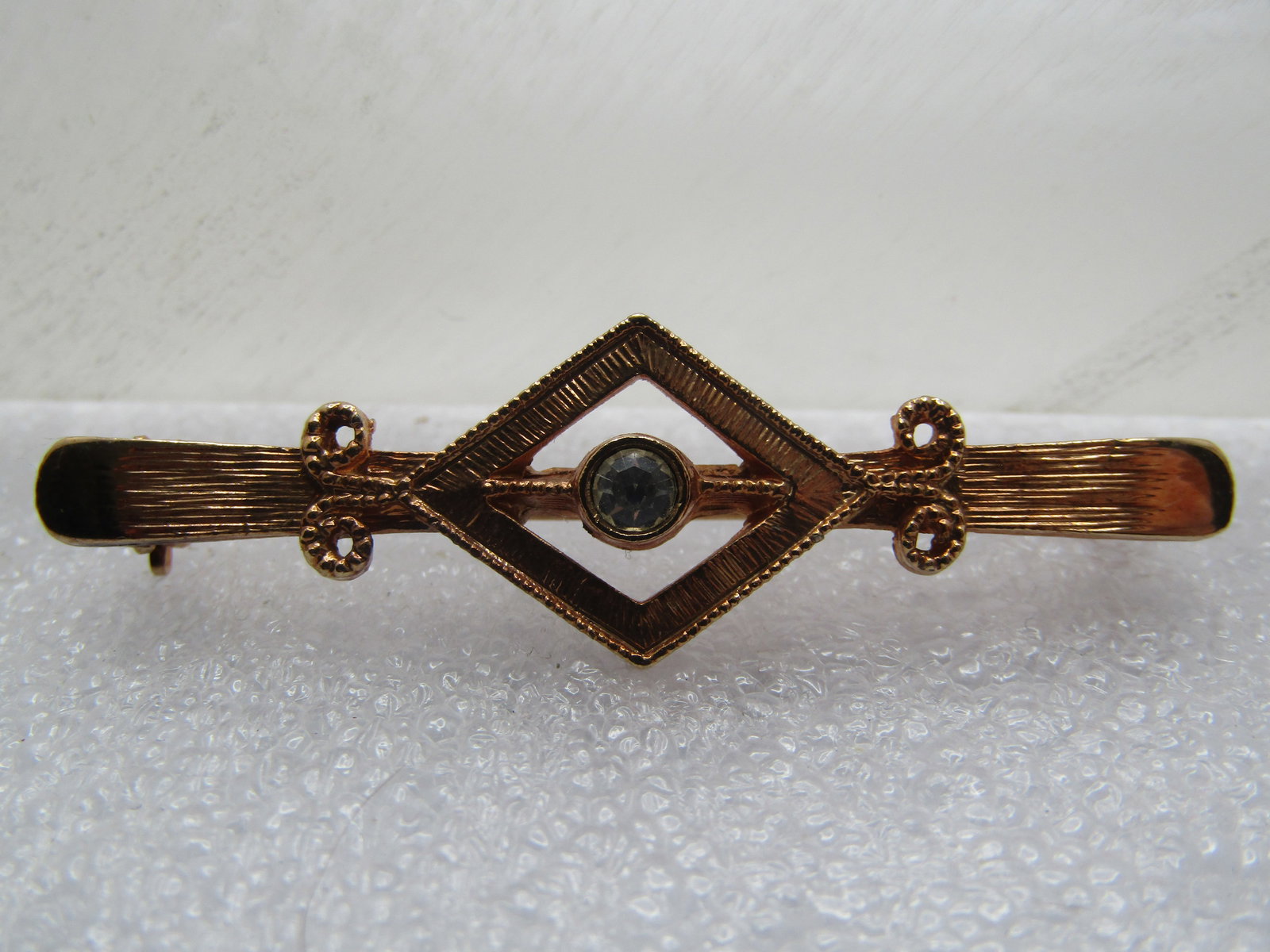 Vintage Bar Brooch with Rhinestone, Signed Coventry 1970's-1980's: Vintage Bar Brooch with Rhinestone, Signed Coventry 1970's-1980's. It is appx. 2" wide and 5/8" tall with an open diamond shape at the center with a center 4mm clear rhinestone. Scrolled accents