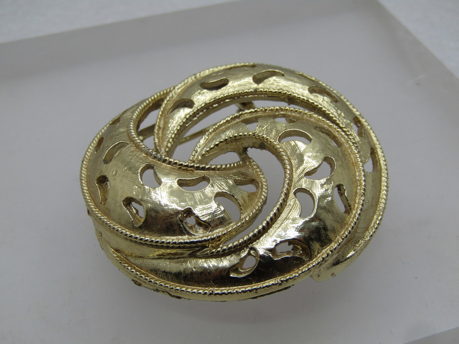Vintage Triple Spiral Brooch, Cut-Out Crescents, 1960's-1970's: Vintage Triple Spiral Brooch, Cut-Out Crescents, 1960's-1970's. This has open work between the three spirals that are each domed . Gold tone and appx. 2" across. Very clean and in very good