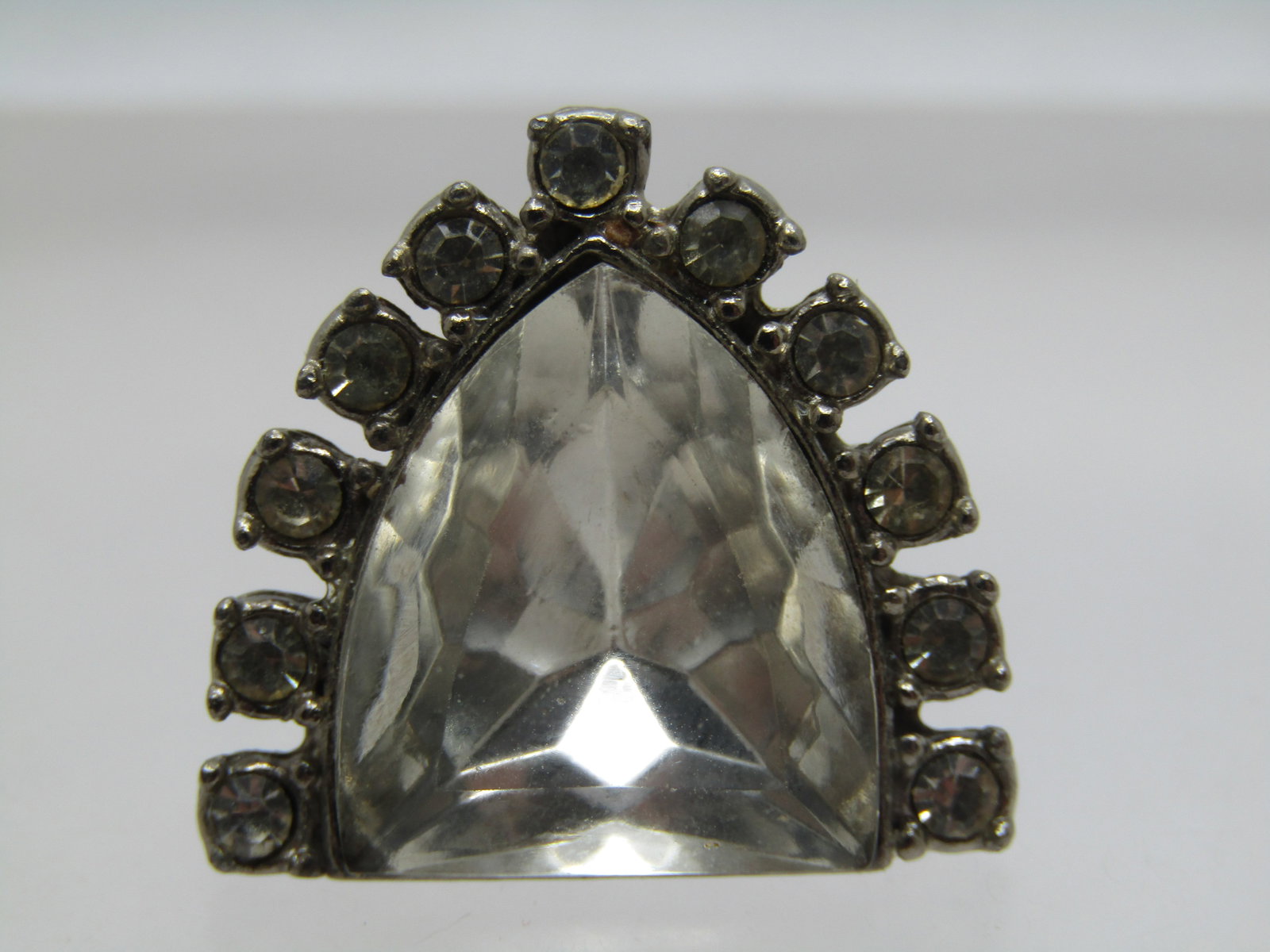 Vintage Rhinestone Art Deco Brooch, 1930's-1940's: Vintage Rhinestone Art Deco Brooch, 1930's-1940's. this is appx. 1" long nad wide with a center heavy faceted stone that is is in the shape of a flat top shield with round clear rhinestones set around