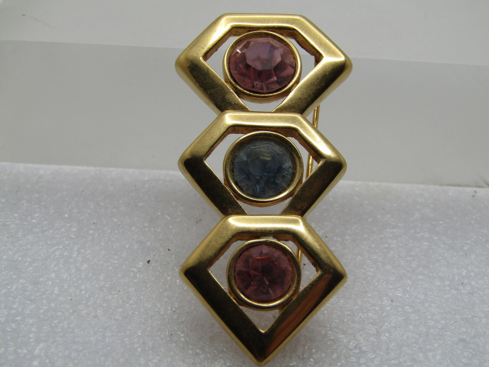Vintage Monet Pink/Blue Rhinestone Brooch, 1970's-1980's: Vintage Monet Pink/Blue Rhinestone Brooch, 1970's-1980's. Three pointed gold tone frames - slightly different in size with a 9mm pink stone in the largest, 8mm blue in the middle and 7mm pink at