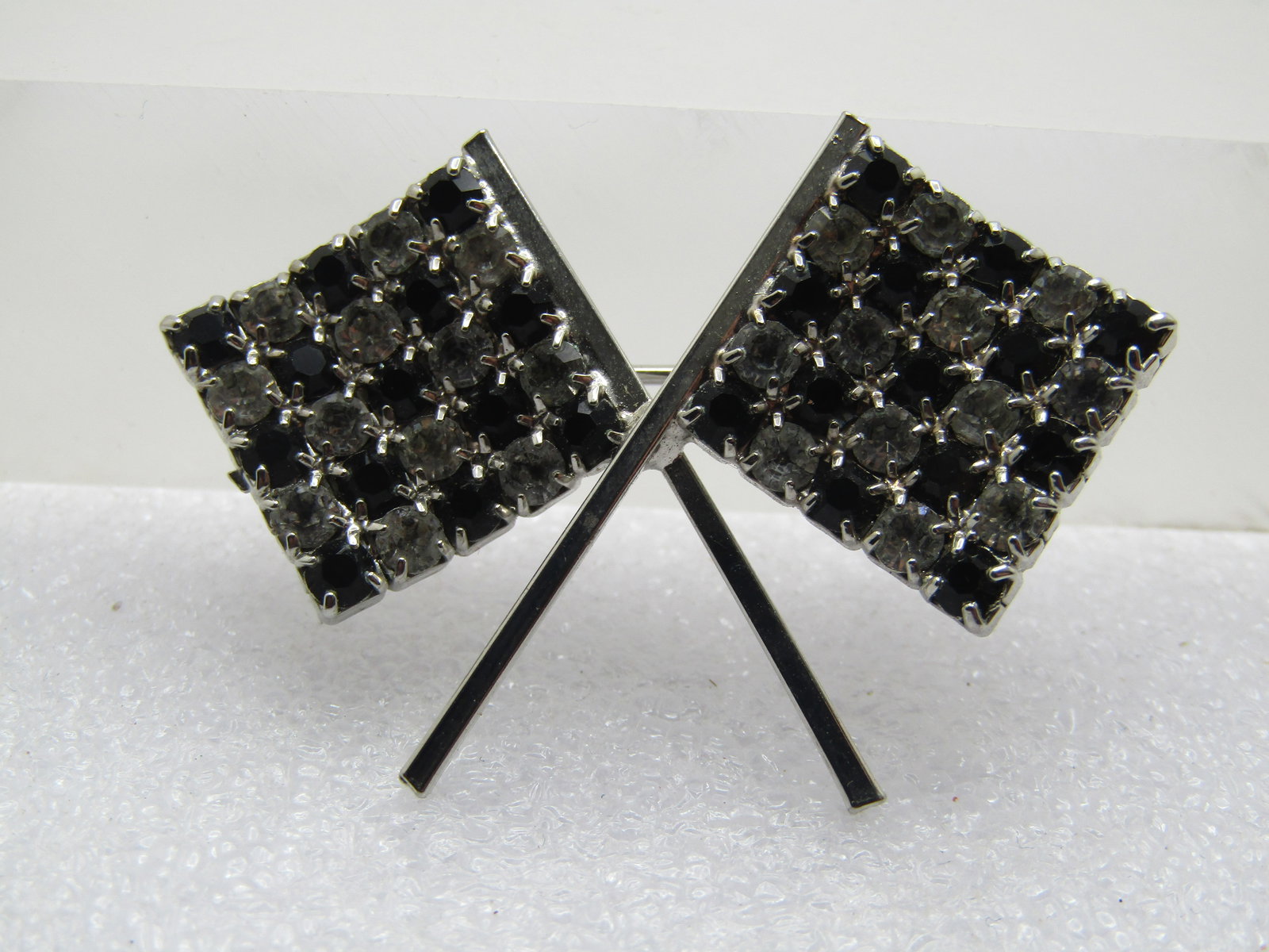 Vintage Rhinestone Checkered Flag Brooch, 1960's: Vintage Rhinestone Checkered Flag Brooch, 1960's. Crossed flags great to wear to a racing event. They brooch is silver tone with closed back settings and prongs on front holding the appx. 2.5mm