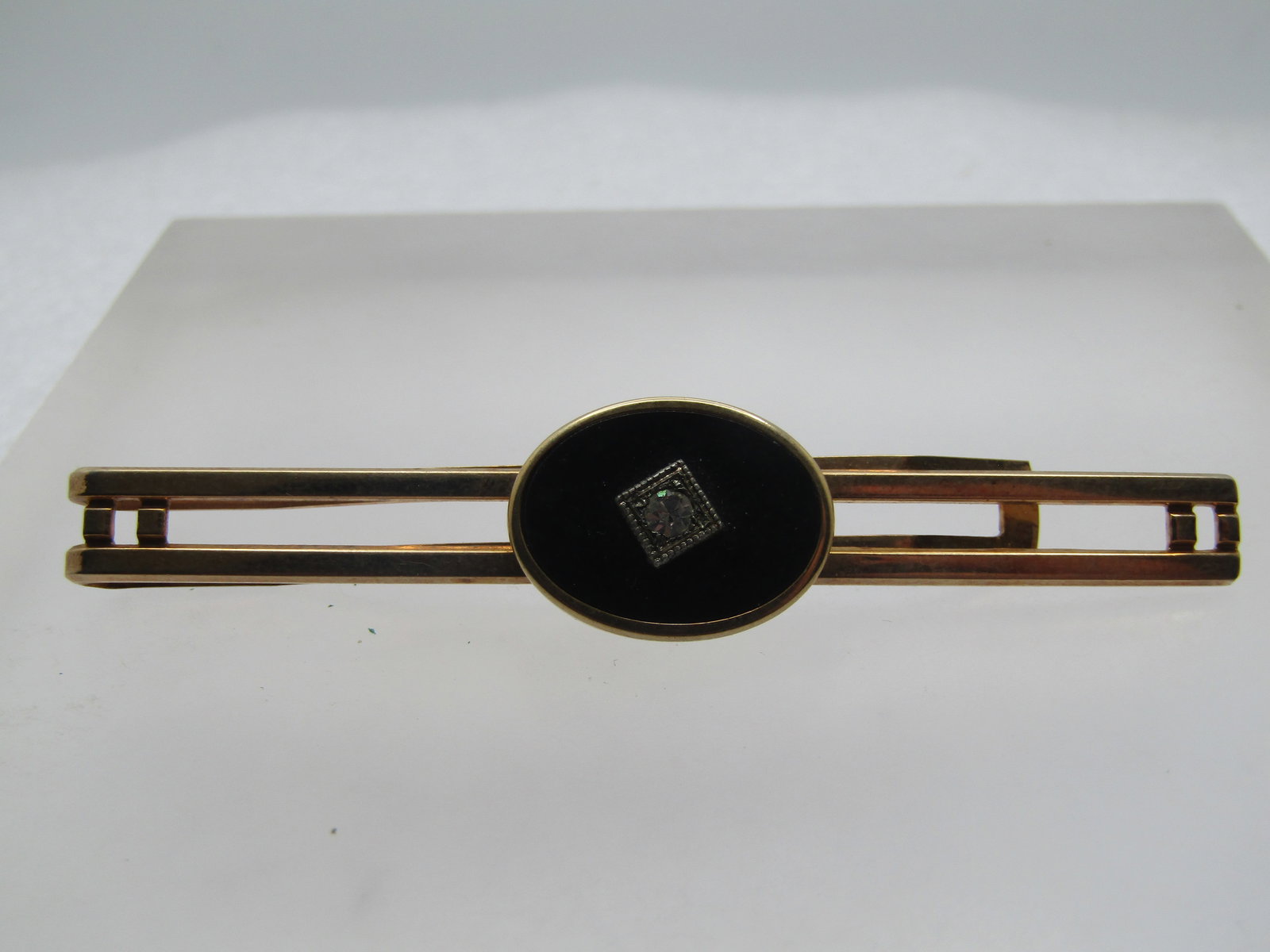 Vintage Anson Tie Bar - Art Deco Themed, Black With Paste Stone, 1940's-1950's: Vintage Anson Tie Bar - Art Deco Themed, Black With Paste Stone, 1940's-1950's. This is appx. 2-7/8" wide with an open double bar top and an oval bezel-shaped black glass stone with a 2.5mm clear rhin