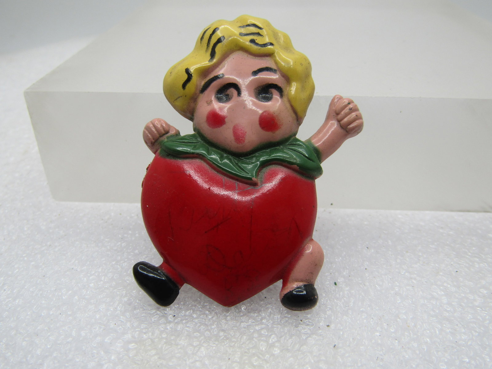 Vintage Plastic Strawberry Brooch, 1930's-1940's: Vintage Plastic Strawberry Brooch, 1930's-1940's. Cute little blonde girl with black shoes and rosy cheeks with a large red strawberry heart-shaped body and green collar of leaves. Appx. 2" tall