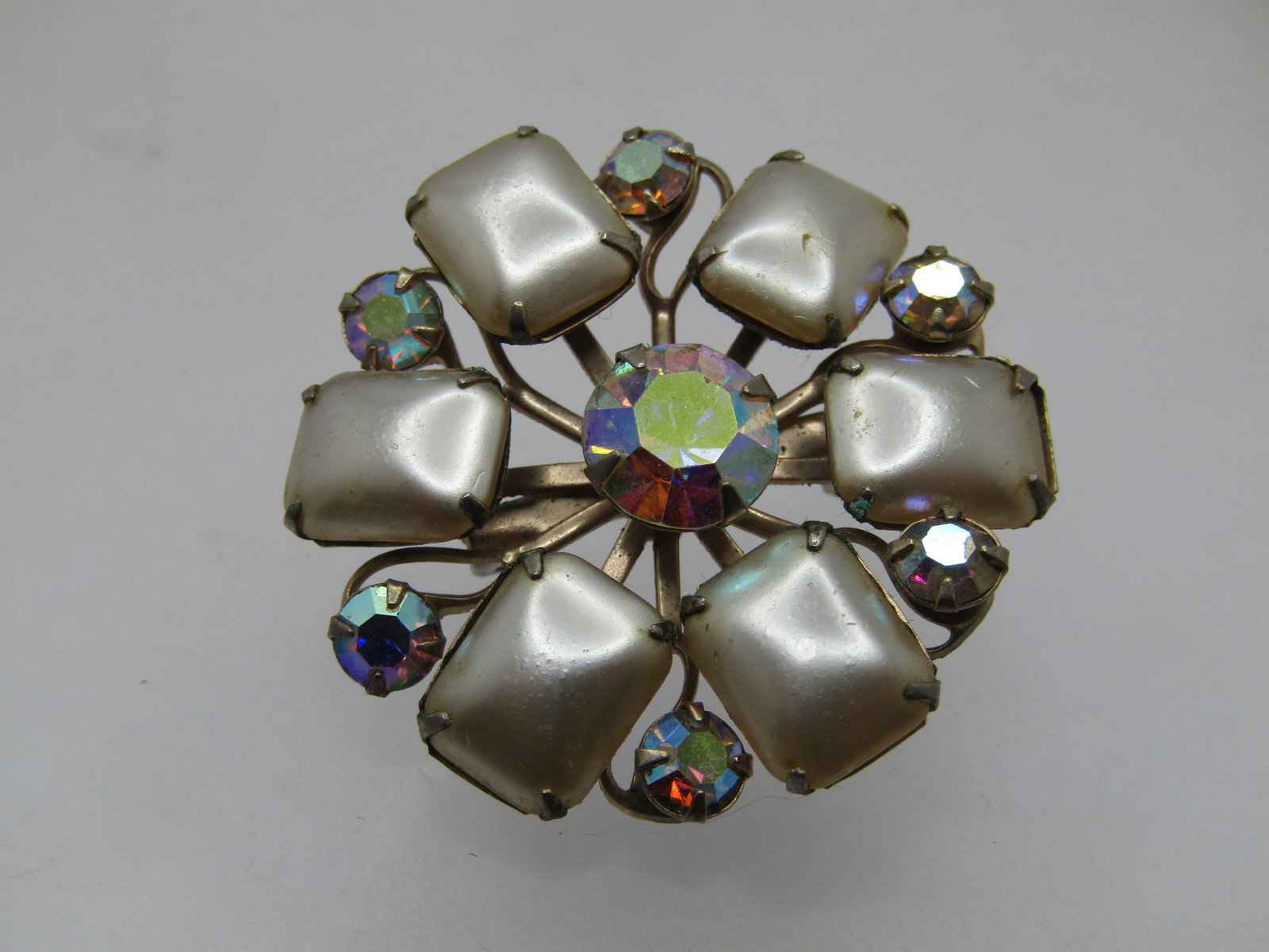 Vintage Faux Pearl Aurora Borealis Rhinestone Brooch, 1940's-1950's: Vintage Faux Pearl Aurora Borealis Rhinestone Brooch, 1940's-1950's. This is a 1-1/3" round brooch with rectangular faux champagne pearls with 4mm round aurora borealis rhinestones between and an 8mm