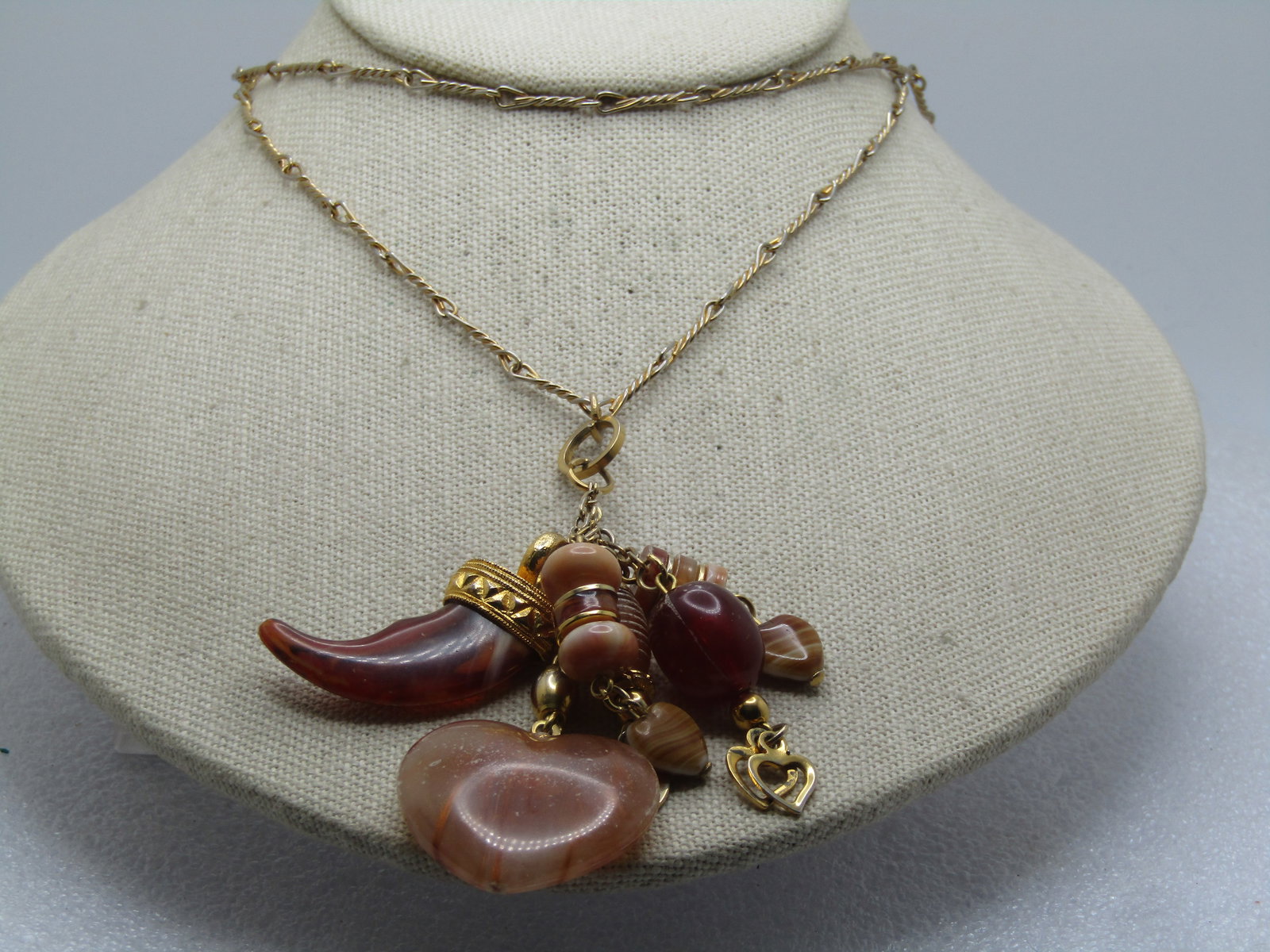 Vintage Mixed Glass & Plastic Hearts & Italian Horn Charm Necklace, 28", 1970's-1980's: Vintage Mixed Glass & Plastic Hearts & Italian Horn Charm Necklace, 28", 1970's-1980's. Gold tone appx. 2mm twisted and loop end link 28" chain with barrel clasp. At the front are three mix beaded