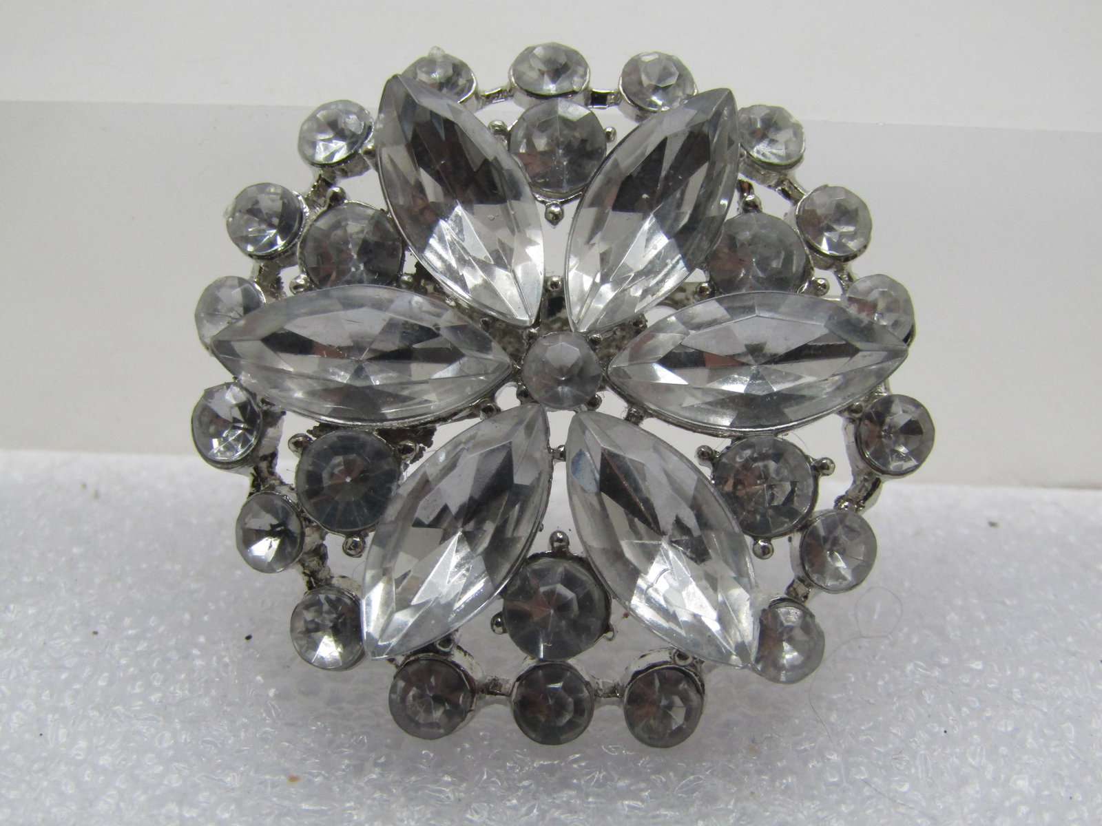 Early 1900's Sash Buckle, Czech Glass, 5": Vintage Clear Rhinestone Blossom Tiered Brooch, 1970's-1980's. This si appx. 1.5" round. The rhinestones are acrylic - all clear and bright. There are two tiers of round that are apx. 2.5mm with one i