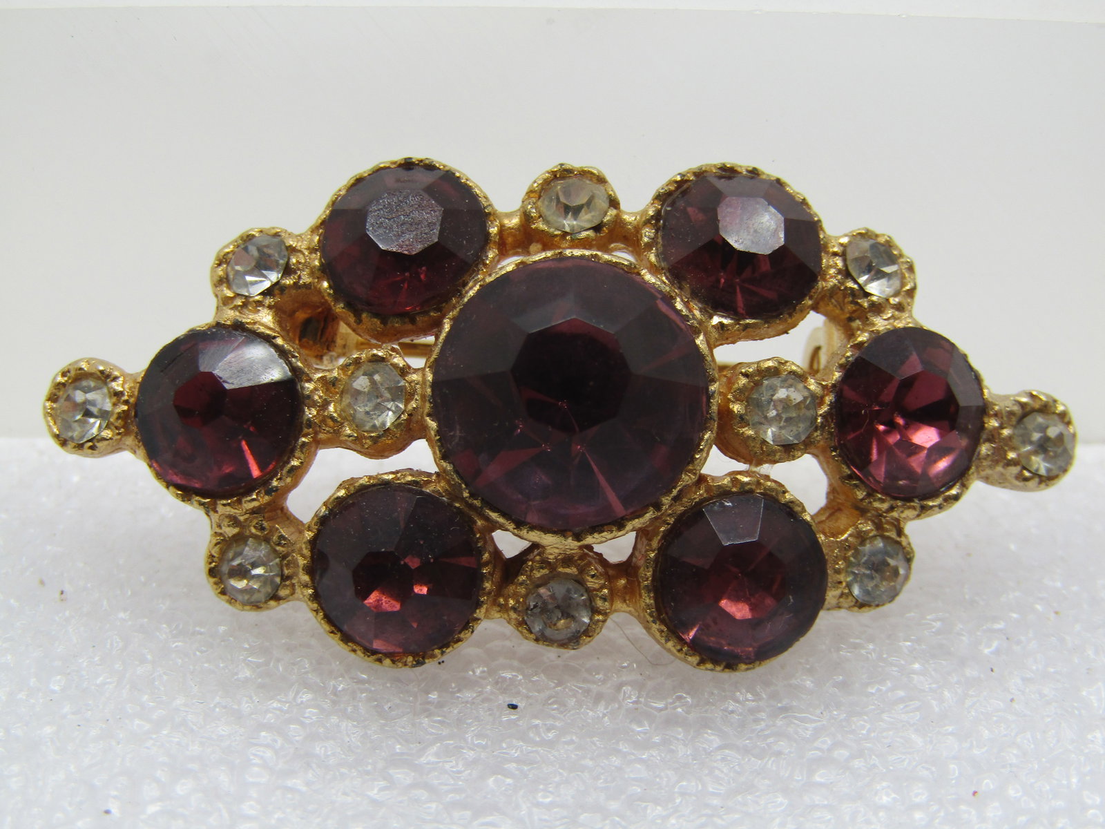 Vintage Purple & Clear Rhinestone Brooch, 1960's-1970's: Vintage Purple & Clear Rhinestone Brooch, 1960's-1970's. This has larger purple rhinestones and smaller clear. The purple as an 11mm stone in the center that has an old mine cut with the shorter table