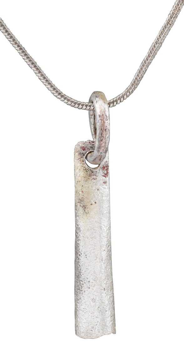 VIKING TUBULAR PENDANT NECKLACE, 9TH-11TH CENTURY AD: About 1 1/8" (1.09") in length, of elegantly reeded elongated conical form. Opened butted seam at the side. With its original suspension ring. These were strung on necklaces along with beds and