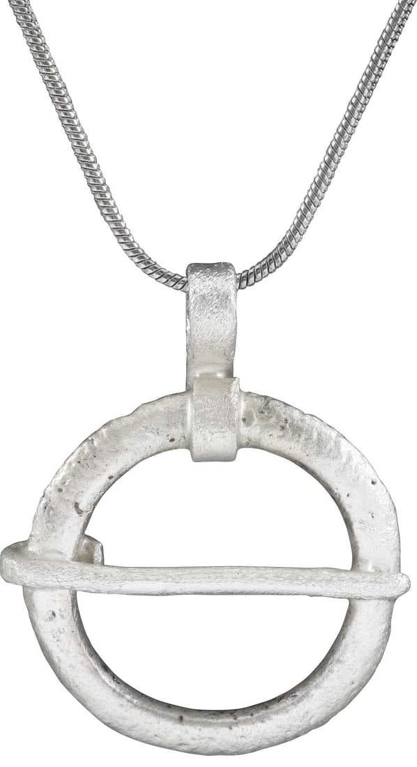 VIKING PROTECTIVE BROOCH, C.900-1050 AD: Silvered bronze of broad form, under 1” (0.97”) diameter. Rounded faces and ridged edges. When fastened to the jerkin, these small metal brooches provided a measure of protection against