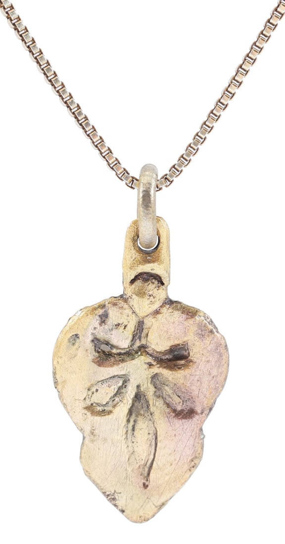 FINE VIKING HEART PENDANT, 9TH-10TH CENTURY AD: Gilt bronze. Just under 7/8" total height (0.91") of natural form with indented sides. The field with a pentafoil in bold relief. Characterful surface lightly textured from burial. Made by the open fa