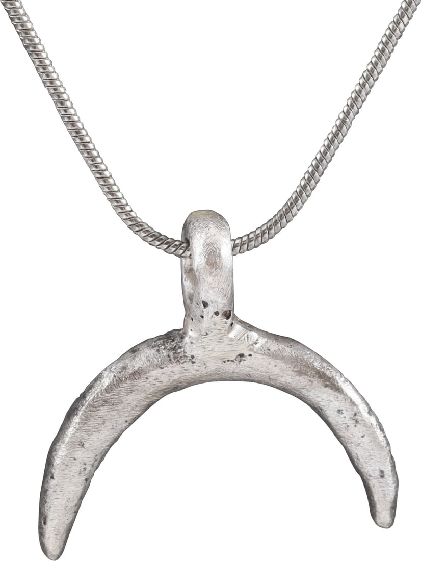 VIKING LUNAR PENDANT NECKLACE, 10TH-11TH CENTURY: Just under 1" width (0.95"). Representing the god Mani, brother of Sol, the sun. Full proud section tapering from the center to the tips. As expert navigators, the constellations signified mystery