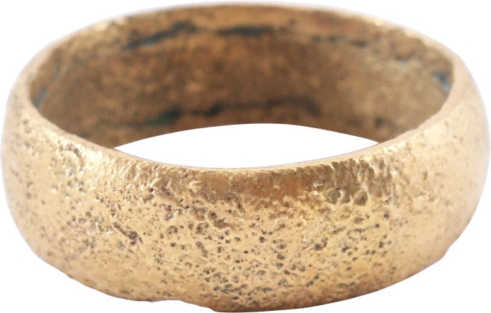 VIKING WOMAN’S WEDDING RING, SIZE 8 3/4: 9th-11th century AD, Gilt bronze with rounded face. 6.5mm width, size 8 3/4. Cast with a central core to distribute the metal and heat. The core then laboriously removed by hand and the remnants are v