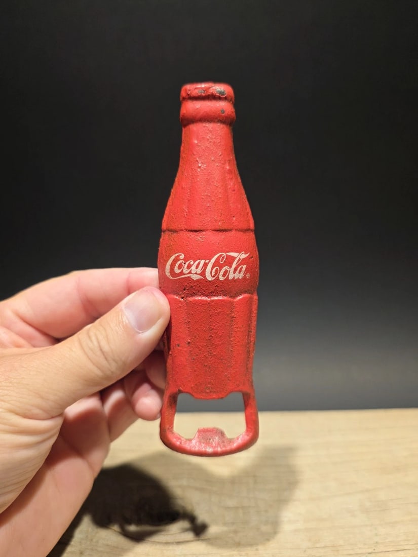 Cast Iron Coca Cola Bottle Opener: 5 1/2" Long Nice reproduction coca cola bottle opener. Nice aged red color. All cast iron. Hard to tell its age! Reserve: $15.00 Shipping: Domestic: Flat-rate of $9.00 to anywhere within the