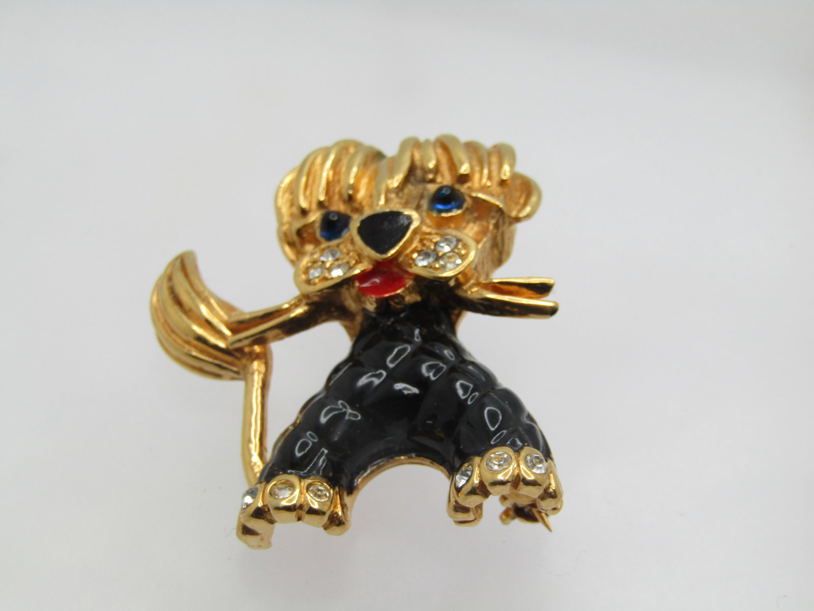 Vintage Enameled Dog Brooch signed Carven Depose, French, 1950's-1960's: Vintage Enameled Dog Brooch signed Carven Depose, French, 1950's-1960's. The dog has floppy fury on it's forehead with blue glass cabochon eyes, balck enameled nose, rhinestone muzzle and paws, red en