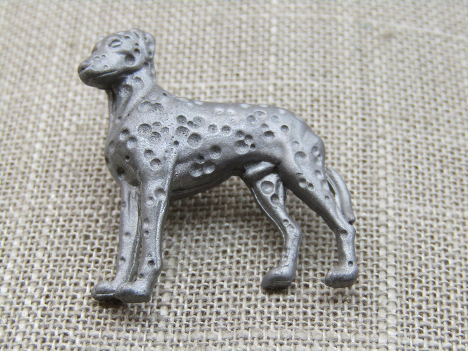 Vintage Pewter Dog Tack Pin. Possibly Dalmation. 1.25": Vintage Pewter Dog Tack Pin. Possibly Dalmation. 1.25" tall and 1-1/8" wide. It has spots that are recessed areas throughout the dog's body. Very good condition. Not signed. 1980's-1990's. (INV.