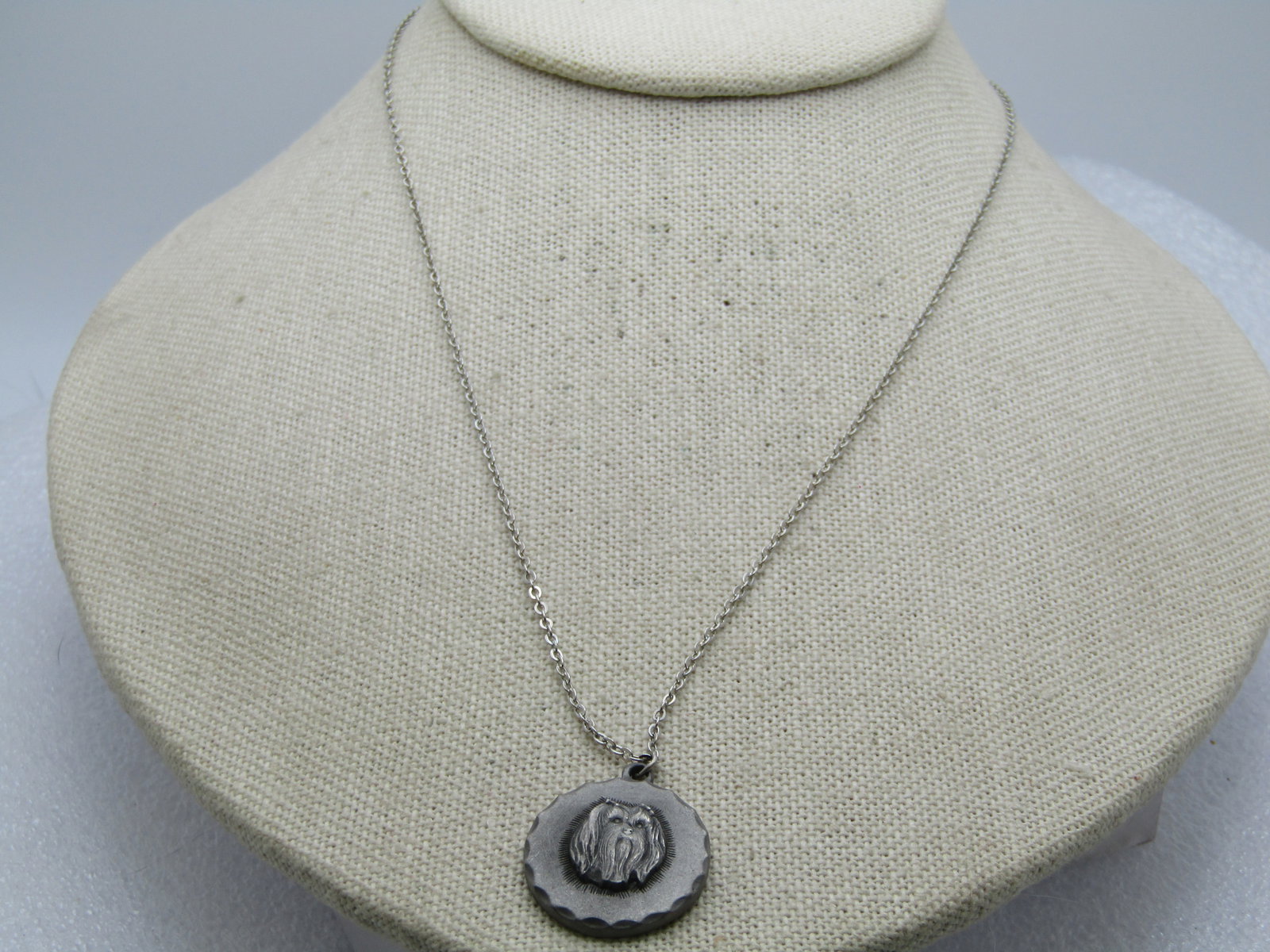 Vintage Maltese Dog Pewter Necklace, 1980's, Rawcliffe Signed, 18": Vintage Maltese Pewter Necklace, 1980's, Rawcliffe Signed, 18". This has a raised Maletese Head on a round pewter based with notched accents framing the pendant. The pendant is appx. 1" round. 1mm