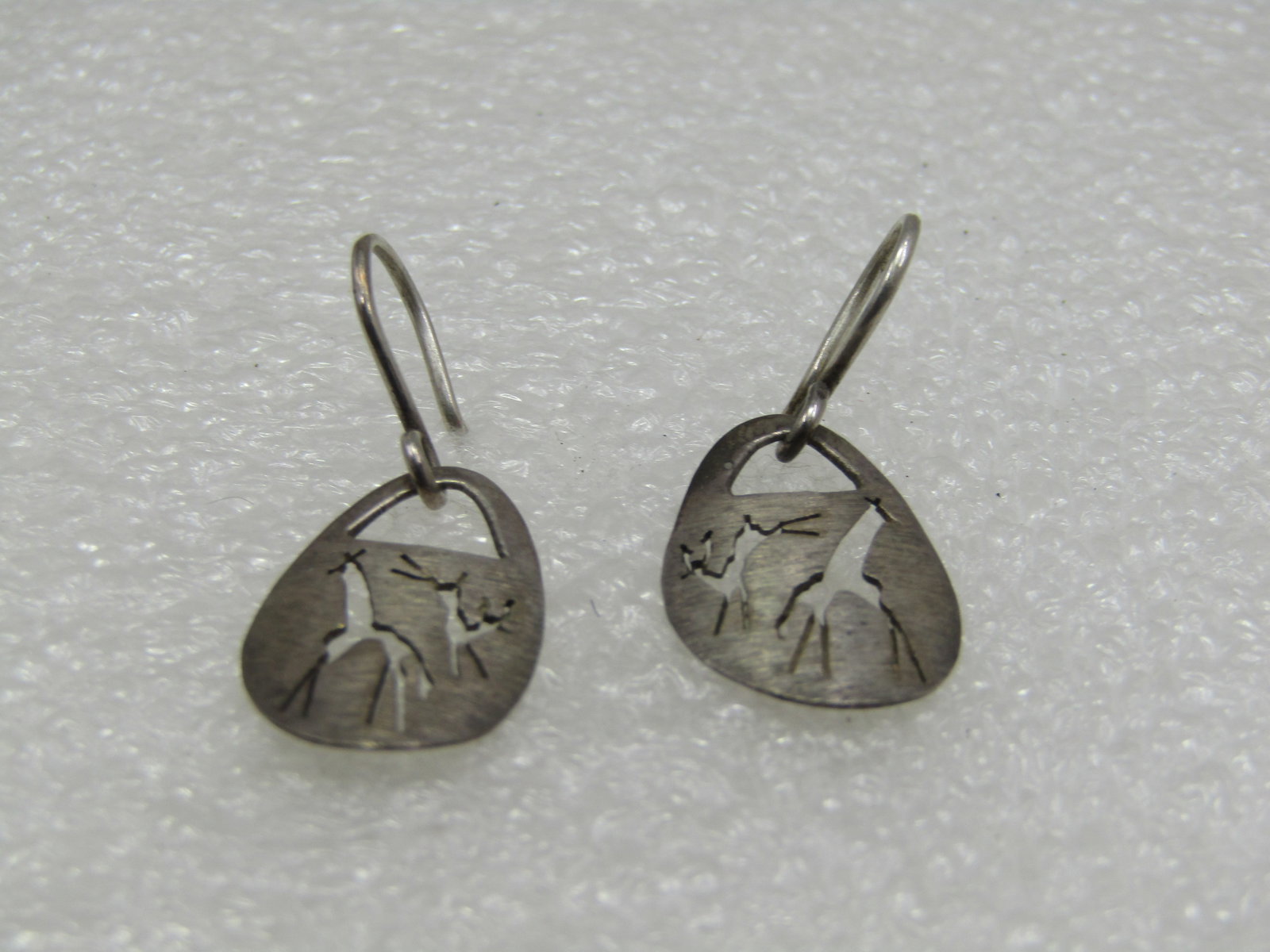 Vintage Sterling African Giraffe and Antelope Earrings, Pierced: Vintage Sterling African Giraffe and Antelope Earrings, Pierced. Appx. 1" long. 3/4"wide. Marked sterling and tested. Weight is appx. 1.87 grams. Oval shaped with a cutout of a giraffe and an