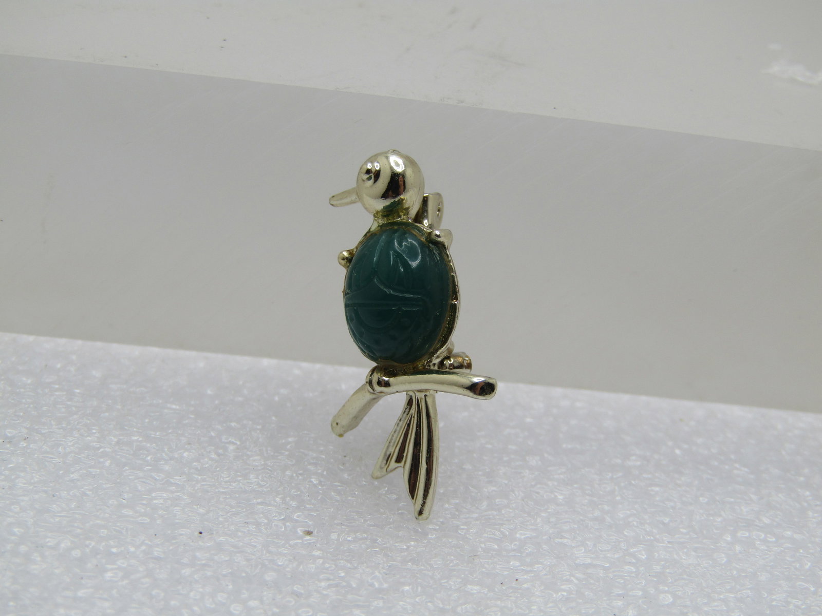 Vintage Green Scarab Bird Brooch, 1960's-1970's.: Vintage Green Scarab Bird Brooch, 1960's-1970's. It is a petite pin - a bird on a branch with a blue 8.5mm by 7.5mm scarab that gold tone but in some lights it looks silver tone . It is appx. 1"