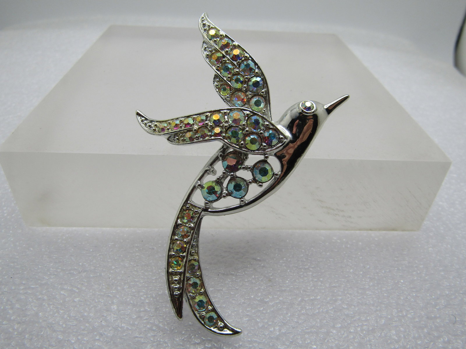 Vintage AB Rhinestone Bird Brooch, Sarah Coventry, 1960's: Vintage AB Rhinestone Bird Brooch, Sarah Coventry, 1960's. Silver tone bird of paradise with clear aurora borealis rhinestones in it's body and wings and eye. It is appx. 3" long and 2" tall. Very cle