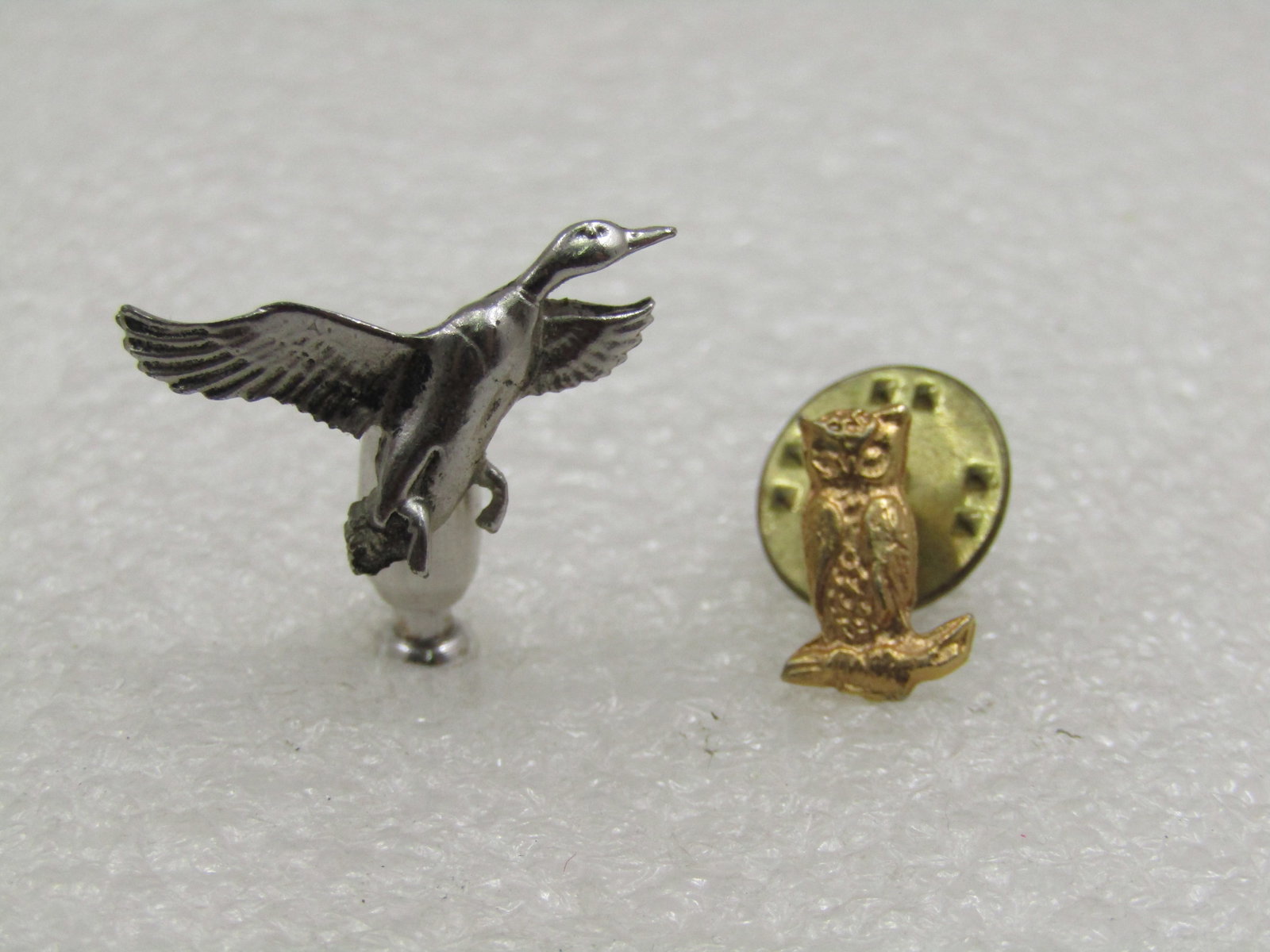 Two Vintage Pack Pins, Duck in Flight & Owl, 1970's-1980's: Two Vintage Pack Pins, Duck in Flight & Owl, 1970's-1980's. The duck is possibly pewter and has a very short stick-pin like pin in that it curves down and not out like a traditional tack pin with a