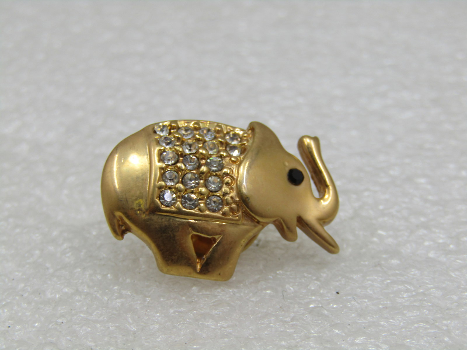 Vintage Rhinestone Elephant tack PIn/Brooch, Gold Tone: Vintage Rhinestone Elephant Tack Pin, Gold Tone, 1" by 3/4". The elephant is slightly domed with clear rhinestiones covering much of its back and a black rhinestone eye. Very good condition. Great