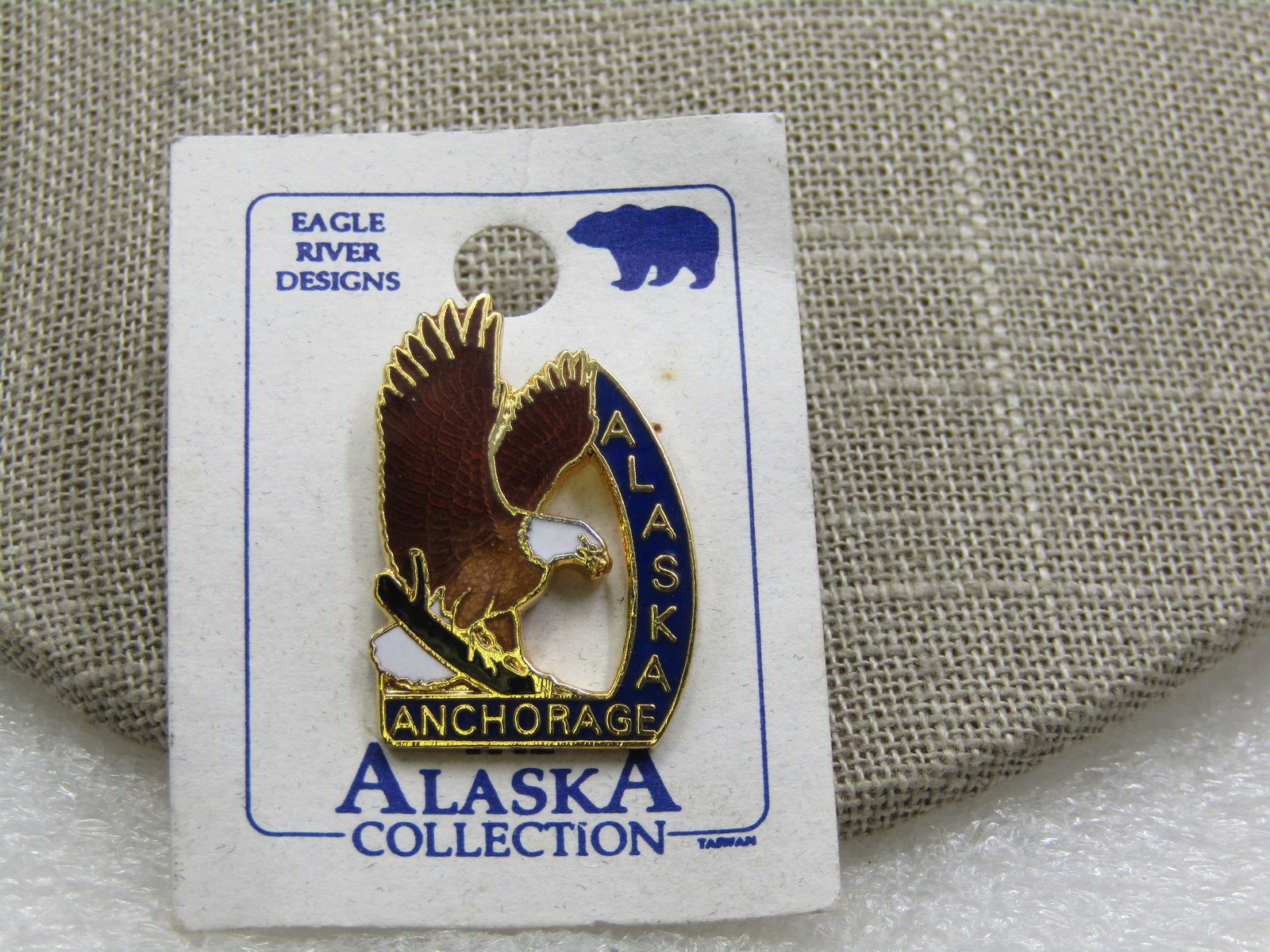 Anchorage Alaska Enameled Eagle Souvenir Tack Pin: Anchorage Alaska Enameled Eagle Souvenir Tack Pin, New on Card. Eagle River Desigins, "The Alaska Collection". Vry good condition. Post mid-century. (INV. W10321.4 SS5825 LEB LD 10/29/21) Reserve: